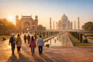Visitors entering the Taj Mahal complex at sunrise in Agra