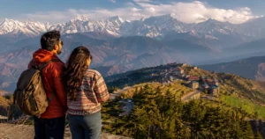 Indian travelers viewing the Himalayan mountains from a scenic Himachal Pradesh viewpoint